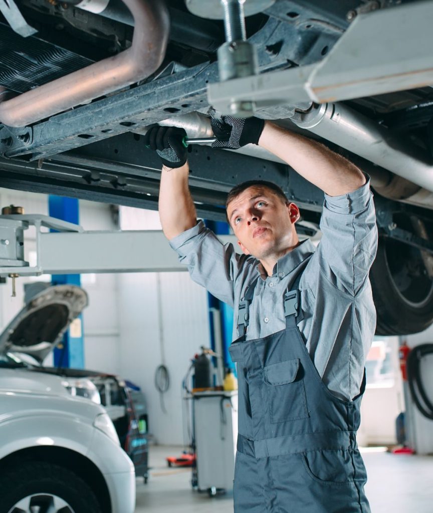 Mechanic underneath a vehicle during repair work - Car Repairs Bicester